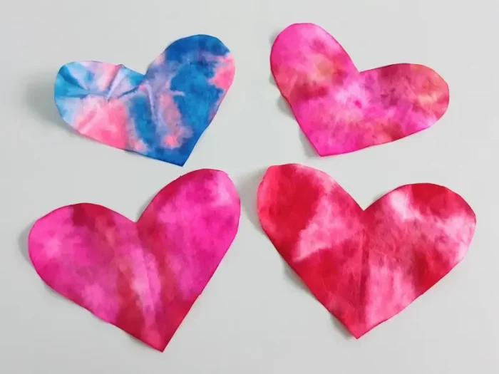 Coffee Filter Heart Craft Coffee filter hearts with tie-dye designs.