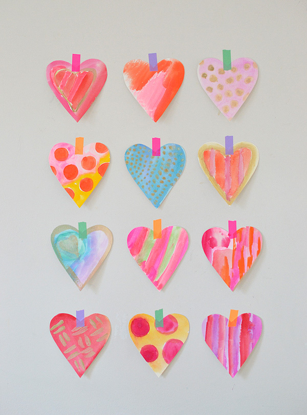 Watercolor Hearts Four rows of colorful watercolor hearts taped to the wall.