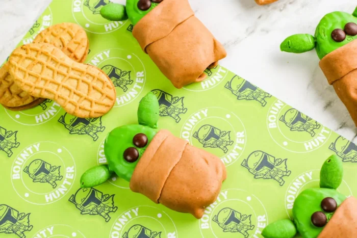 Baby Yoda Cookies Yoda decorated cookies on a Star Wars background.