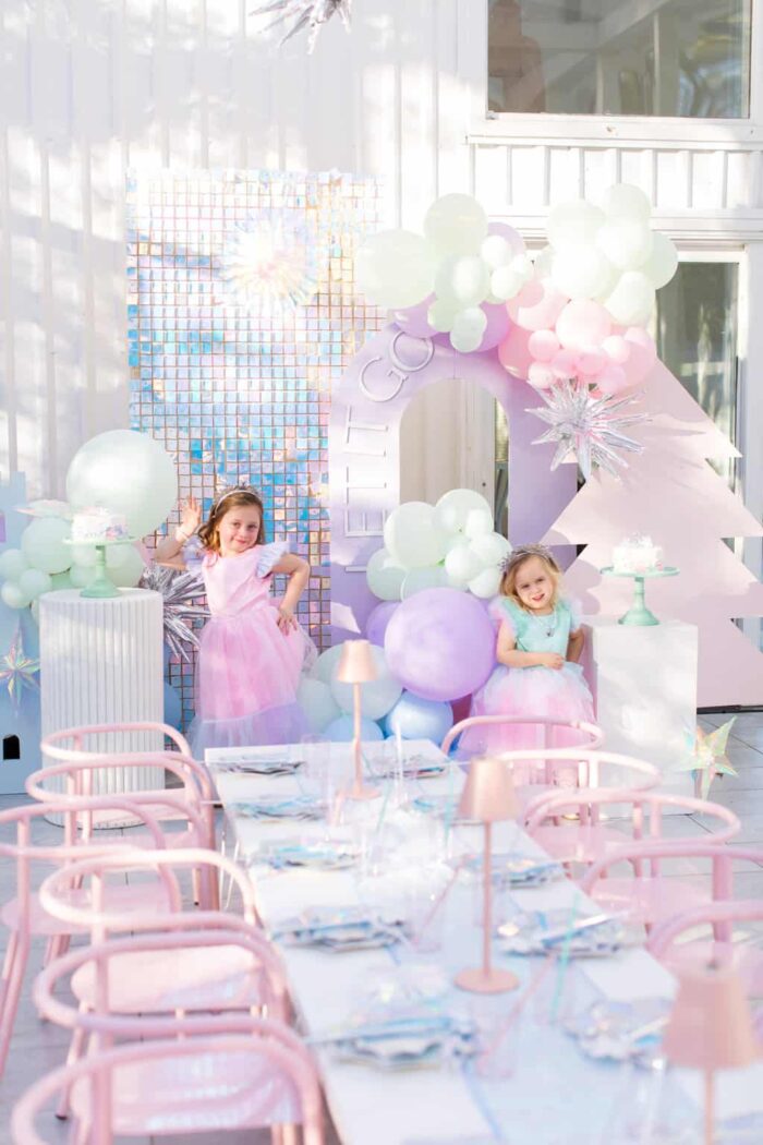 Frozen Party Frozen themed party with a dinner table and two kids posing.