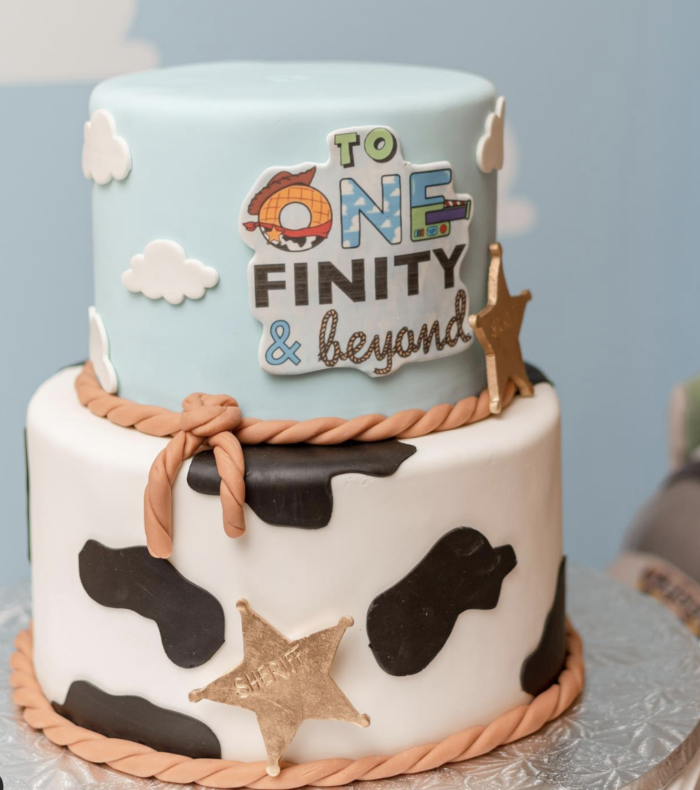 Toy Story Party Toy story cake with the words "to one-finity and beyond" on it.