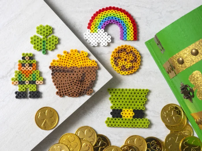 Leprechaun perler bead designs next to fake gold coins. 
