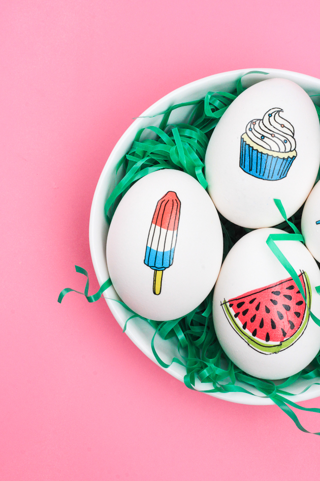 Eggs in a bowl with animated designs on them. 