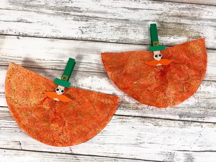 Two coffee filters made into small leprechaun crafts. 
