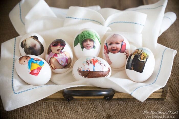Eggs with photos printed on them on a kitchen towel. 