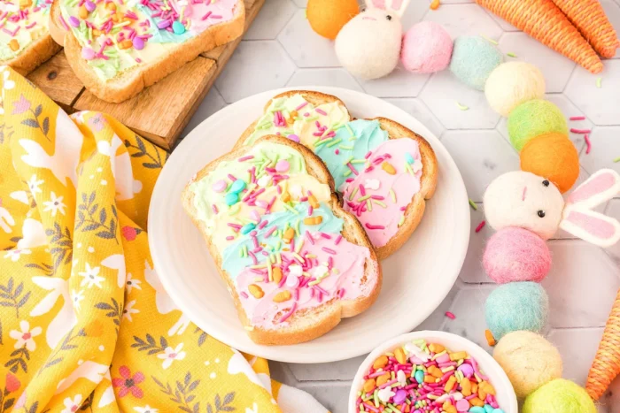 Rainbow Party Toast with rainbow cream cheese and rainbow sprinkles on top.