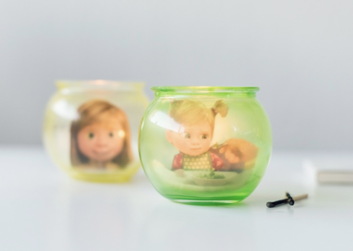 DIY Memory Orbs Glass candle holders with photos of Inside Out characters in them.