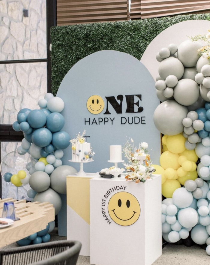 One Happy Dude Birthday Party Balloons around a cake table labeled with "one happy dude".