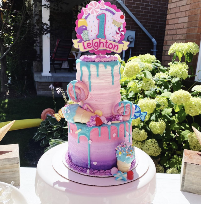 Sweet One Birthday Party Large colorful cake with candy decorations.