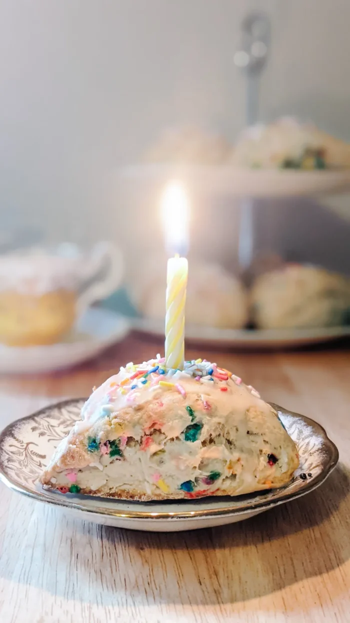 Tea Party Scone with sprinkles and a birthday candle on top.