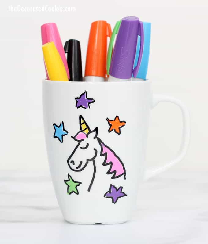 Craft Party Mug with pens in it and a unicorn design on it.