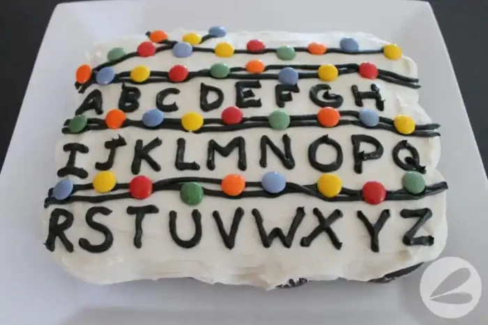 Stranger Things Party Cake with alphabet and colored candies on it.