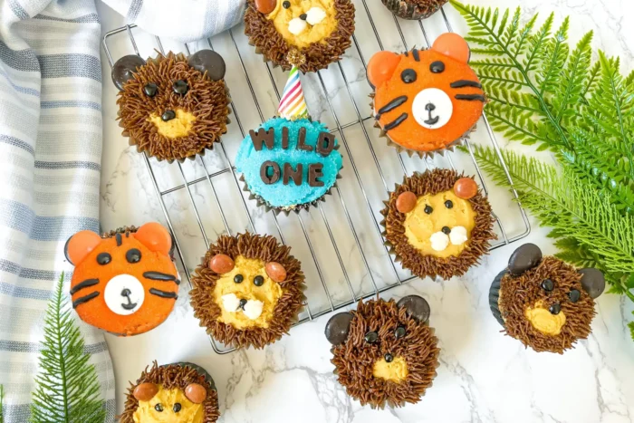 Wild One Birthday Party Overhead shot of animal designed cupcakes.