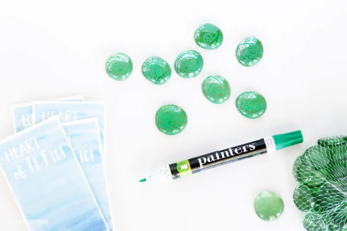 Moana Craft Hearts of Te Fiti craft designed with green pebbles and green markers.