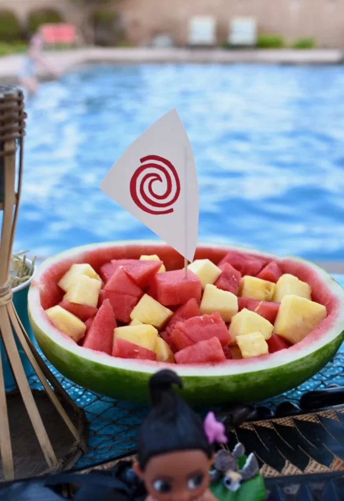 Moana Watermelon Boat Watermelon boat filled with watermelon and pineapple topped with a small boat sail.