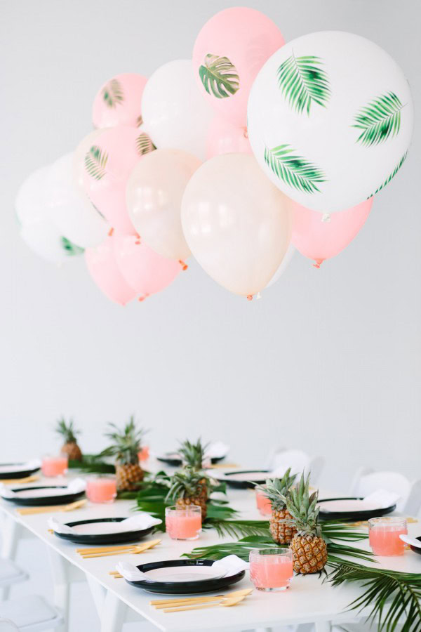 Palm Frond Balloons Palm frond balloons attached to a table.