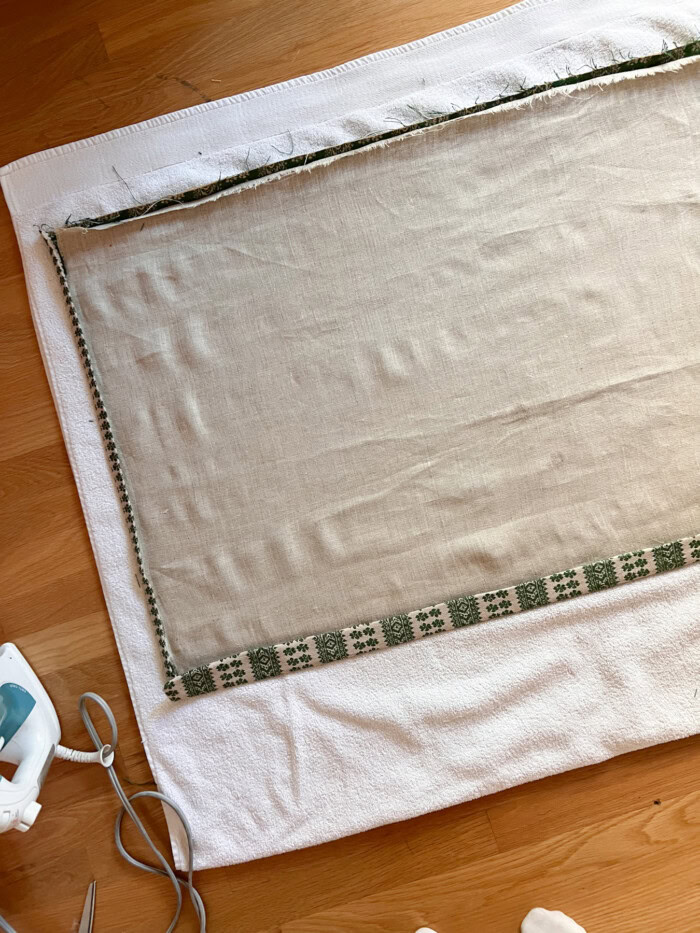 fabric laying on towel on wood floor