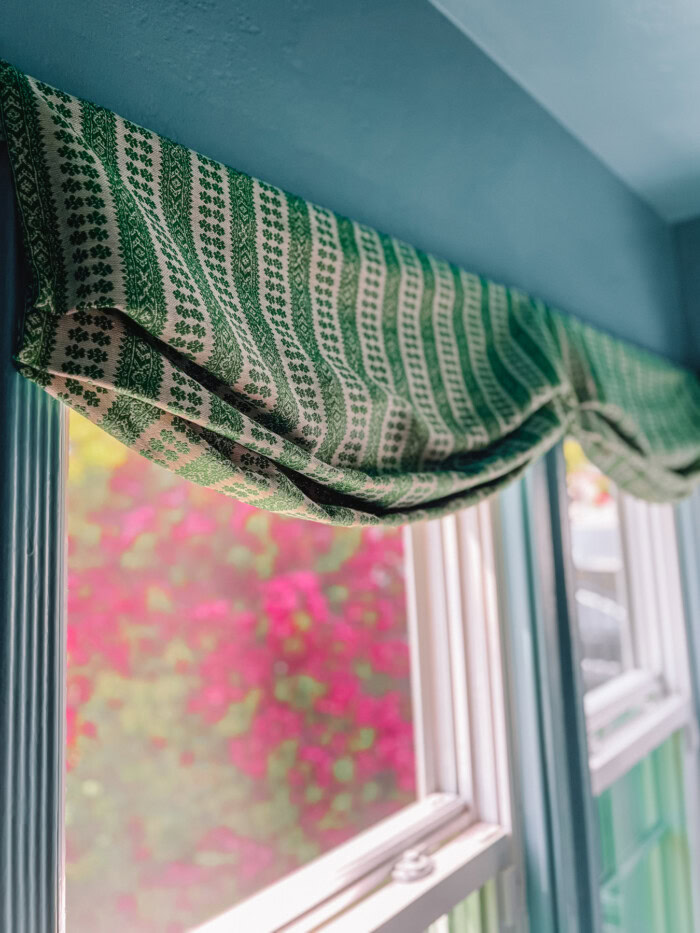 faux roman shade hanging above window