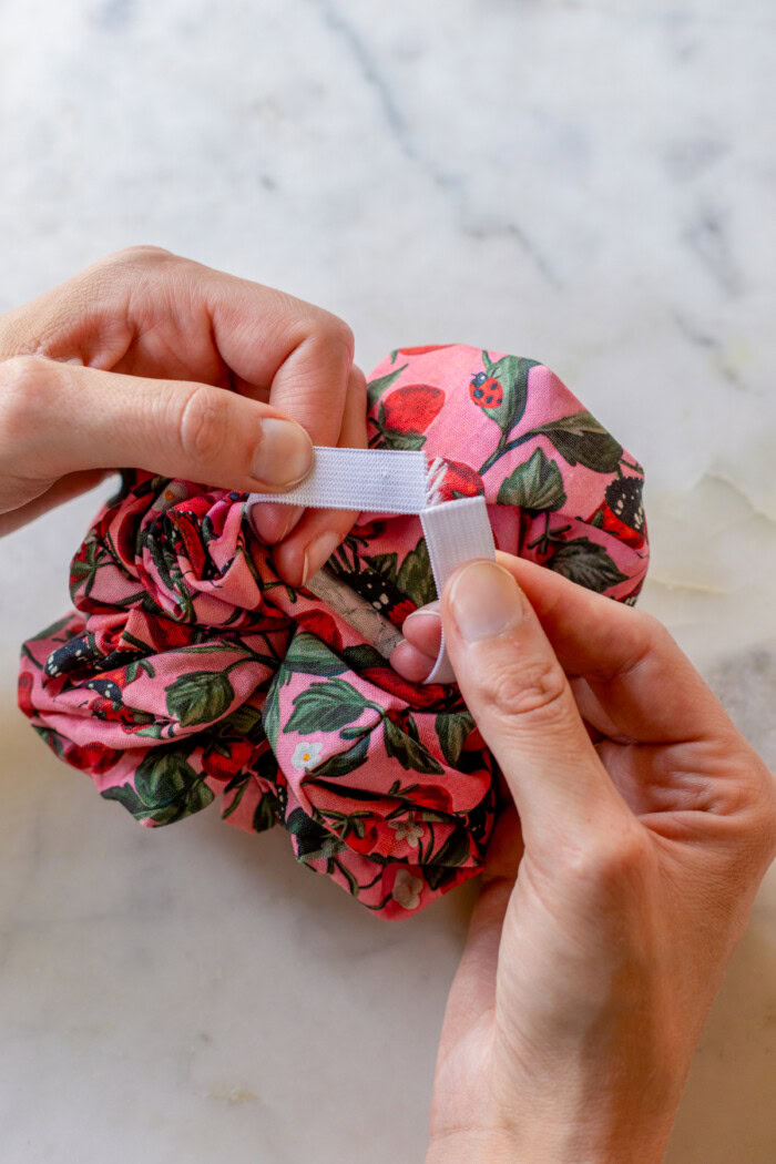 holding two ends of elastic in scrunchie