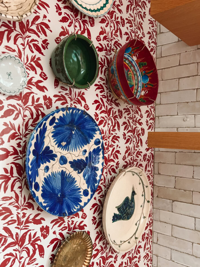 Plate wall on wallpaper with tile and shelves